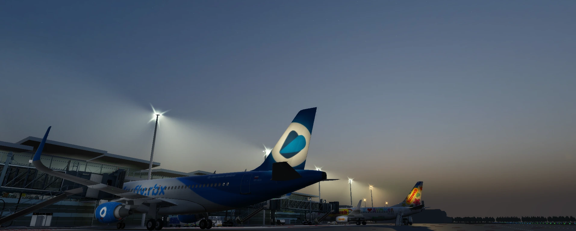 Aircraft parked at gate in the evening.